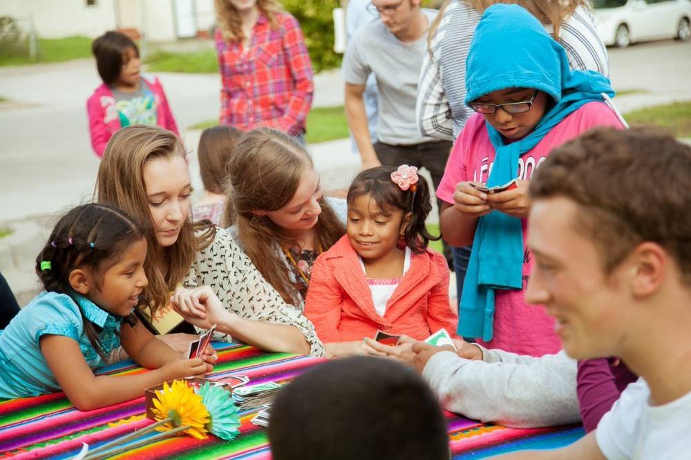 Children sitting at a table doing a craft